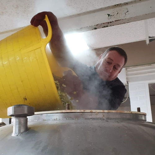 Emptying hops into the brewing tank