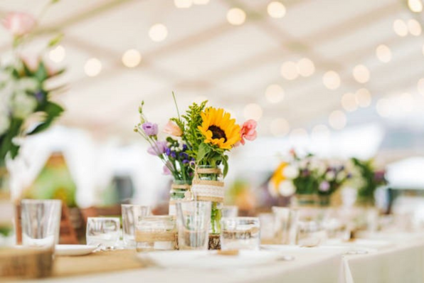 Bouquet of flowers on a big table set for a wedding party